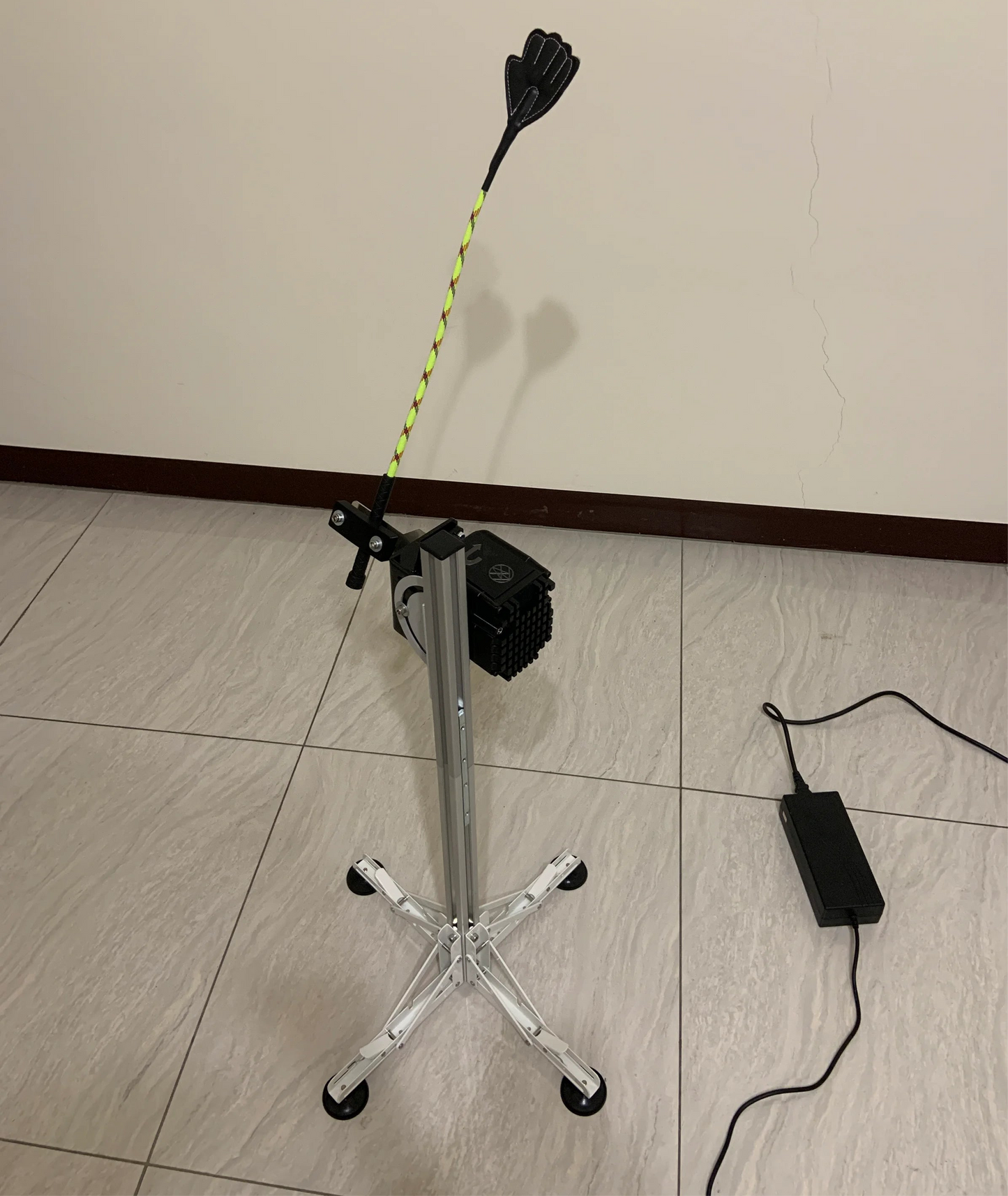 Electric tapping massage machine with a flexible wand attachment and 4-leg suction base.