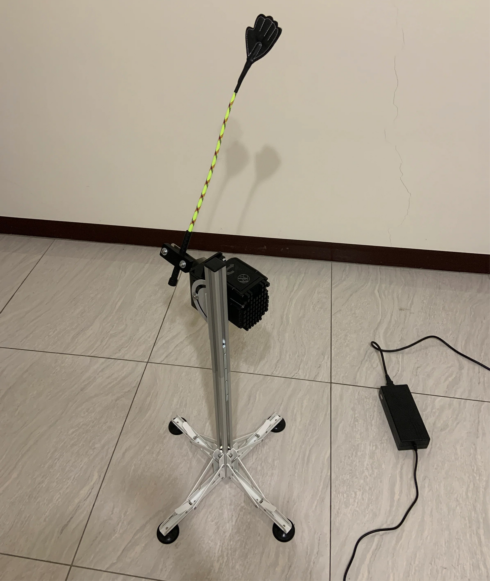 Electric tapping massage machine with a flexible wand attachment and 4-leg suction base.